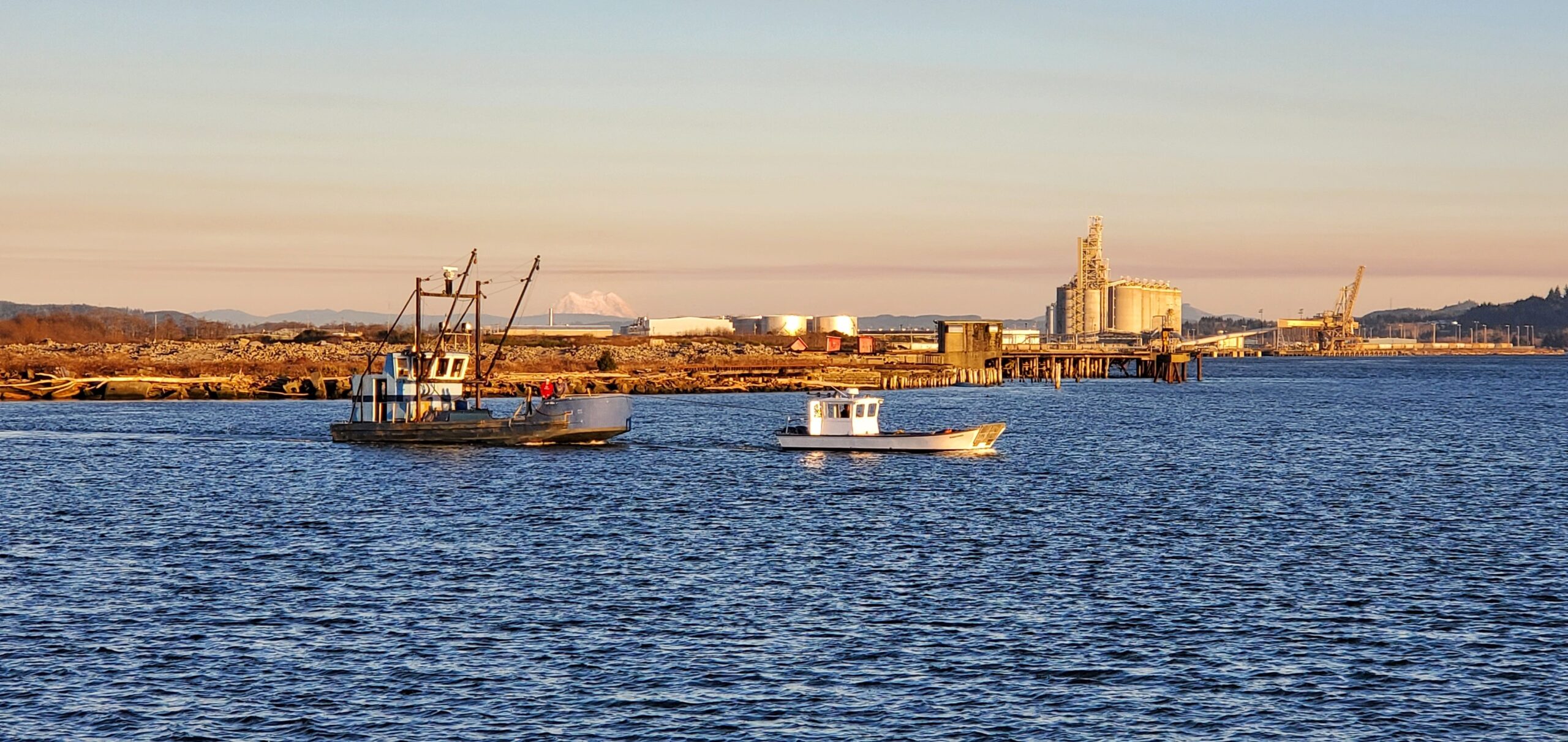 Mouth of Hoqiuam River meets the Chehalis River with Two boats and Biodiesel plant in background.
