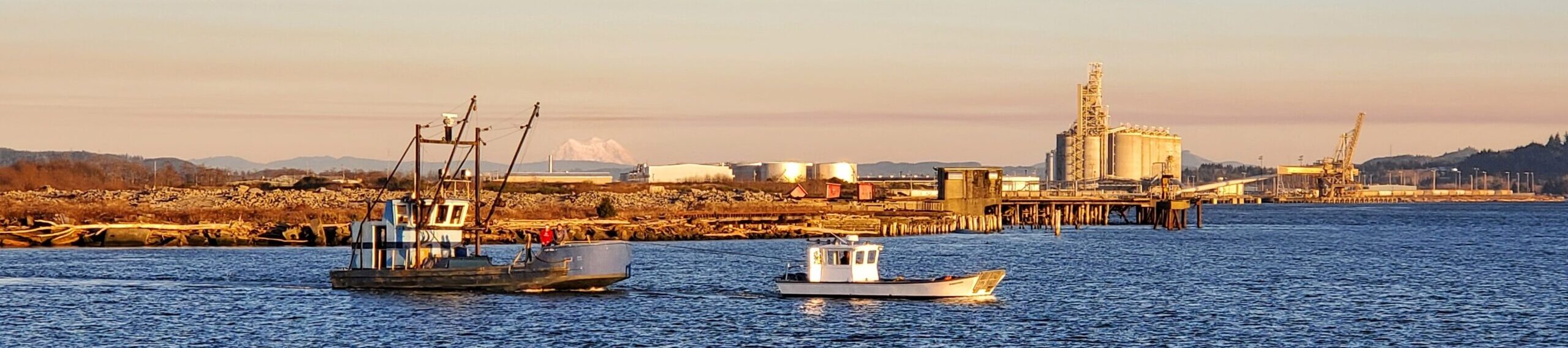 Mouth of Hoqiuam River meets the Chehalis River with Two boats and Biodiesel plant in background.